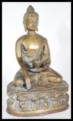 A 20th Century bronze figure of a Buddha in the lotus position wearing decorative robes with one