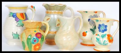 A selection of mid 20th Century hand painted ceramic jugs to include a burleigh ware jug having a