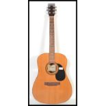 A vintage Encore acoustic six string guitar model EA255. The shaped hollow body having a black