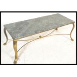 A vintage brass and marble coffee table raised on cabriole legs with hairy paw feet. Veined marble