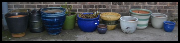 A collection of vintage large stone garden planters each of varying colours sizes and forms.