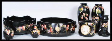A selection of early 20th Century Bretby Cloisonne ware ceramics having hand painted blossom and