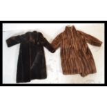 A vintage early 20th Century full length ladies fur coat together with a simulated fur full length