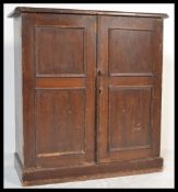 A 19th Century Victorian stained pine school cupboard, twin panelled doors fitted with knob