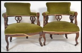 A pair of early 20th Century Edwardian mahogany tub shaped chair, upholstered in green velour