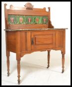 A late 19th Century Victorian walnut marble topped washstand raised on block and turned legs with