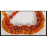 Two vintage 20th Century chinese Amber type prayer bead necklaces, one having circular disc beads
