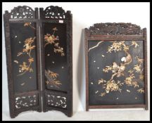 A Japanese Meiji period carved hardwood two fold screen with Shibayama panels decorated with