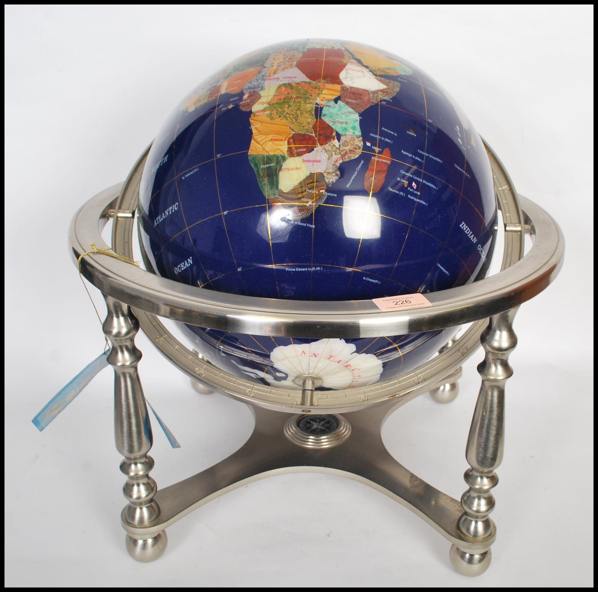 A large vintage style lapis lazuli desk top globe having a chrome gimbal mount with inset semi