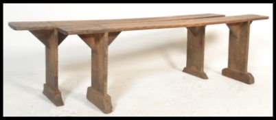 A pair of 19th century French refectory pig benches. Each with shaped single plant tops of fruitwood
