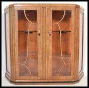 A 1930's Art Deco walnut china display cabinet. Twin astragal fan glazed doors with glass adjustable