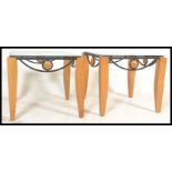 A pair of contemporary 20th Century matching coffee tables, shaped beech uprights united with a cast