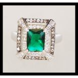 A sterling silver CZ and faux emerald dress ring in the Art Deco style. Weighs 5.4 grams size M.5.