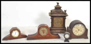 A collection of clocks dating from the 19th Century to include Mantel clocks, Napoleon hat clock