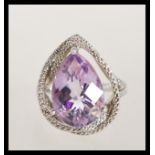 A sterling silver 925 large ring having a large faceted purple amethyst stone with lines of white