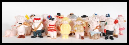 A collection of 25 ceramic novelty ' Piggies ' in the form of pigs in different characters in bright
