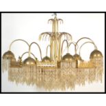 A vintage mid 20th Century large eight branch chandelier ceiling light fixture having gilt