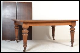 A Victorian oak extending dining table, the rectangular surface with canted corners, raised on
