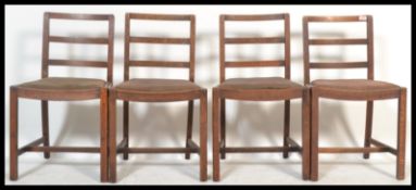 A set of four vintage 20th Century CC Utility oak dining chairs in the manner of Heals raised on