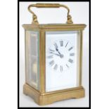 An early 20th Century French brass cased carriage clock having bevelled glass panels. The white