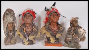 A group cast resin desk top busts in the form of Native American Indians having feathered