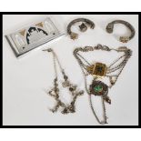 A group of silver white metal jewellery to include white metal Middle Eastern card case, necklaces