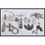 A selection of silver necklace chains and pendants to include an ingot pendant, a filigree crucifix,