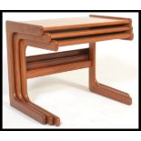 A retro 20th Century Danish influence teak wood nest of three graduating tables raised on L -  shape