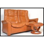 An Ekornes Stressless two seater tan leather Reclining Sofa of Scandinavian design along with a