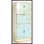 A vintage two tone mid 20th Century upright kitchen unit, an arrangement of glass and panel doors,