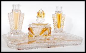 An early 20th Century Art Deco cut glass dressing table set with clear glass and amber glass,