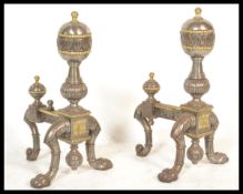A pair of 19th Century Victorian steel and brass andirons / fire dogs raised on paw feet with