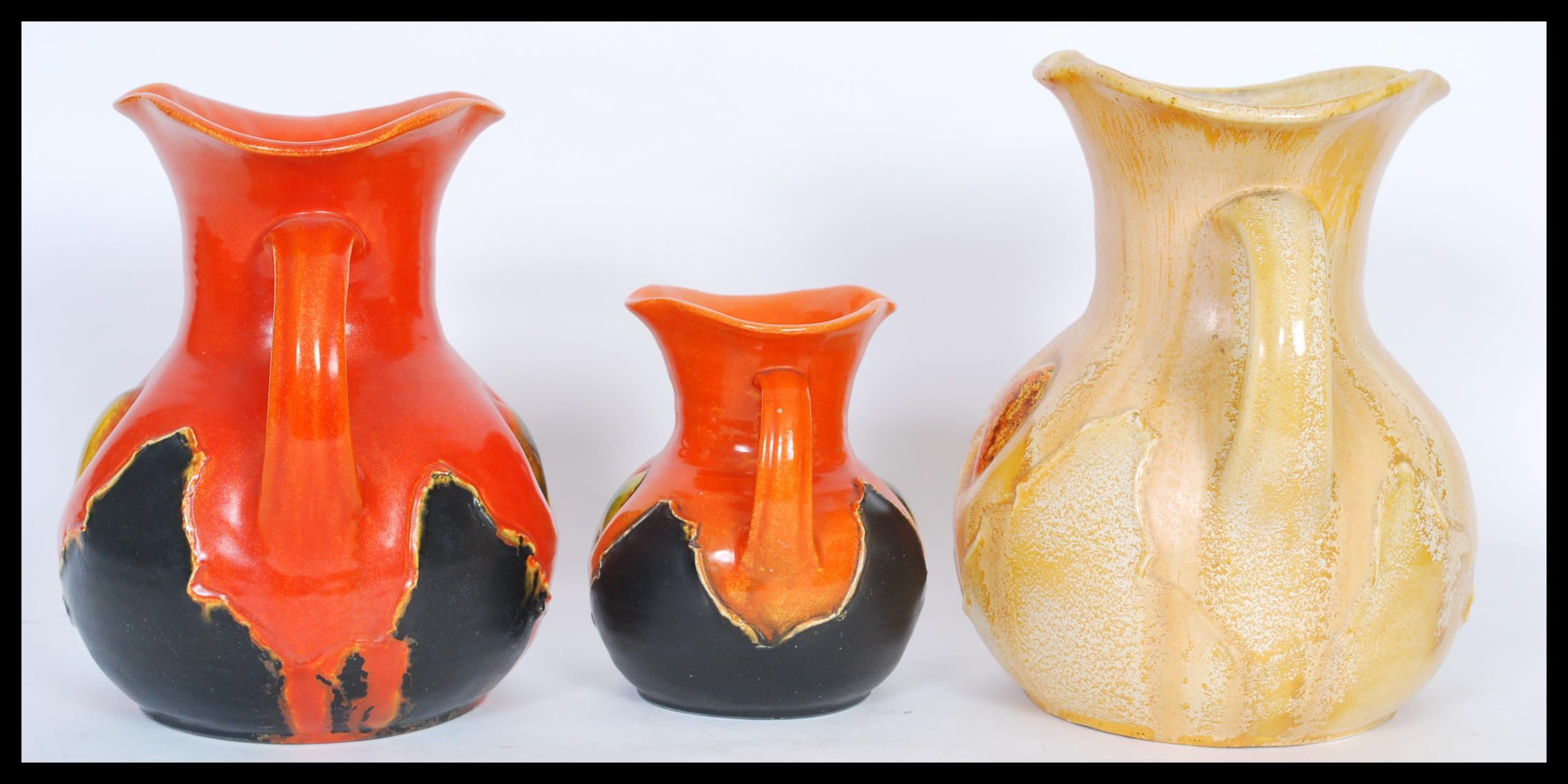 A group of three early 20th Century twin handled vases of bulbous form having flared rims, - Image 2 of 4