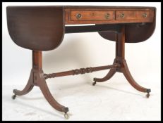 A 19th Century mahogany sofa table, with banded edge, fitted to the frieze with two drawers and