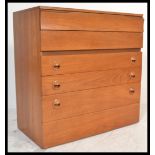 A retro 20th Century teak wood chest of six graduating drawers, flared top with sunken handles