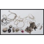 A selection of silver necklace pendants on various different chains to include a heart locket, a