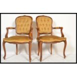 A good pair of French fauteuil / armchairs in mahogany having reeded, carved legs and shaped apron