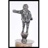 A hallmarked 20th Century Antique style silver novelty bottle stopper having a figural top depicting