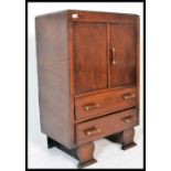 An early 20th Century Art Deco oak tallboy - linen cupboard raised on bracket leg base with cupboard