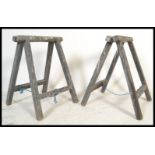 A pair of vintage 20th Century industrial ebonised decorators folding wooden work trestles, block