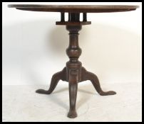 A 19th Century Georgian mahogany tilt top pedestal occasional table with now fixed top over the