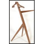 A vintage 20th Century retro wooden valet stand raised on angular legs with tray and hanging section