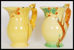 A pair of early 20th Century Burleigh Ware Art Deco water jugs having relief squirrel handles and