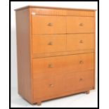 A vintage retro 20th Century teak wood dressing chest, with mirrored hinged lid, above four drawers,