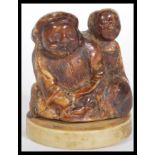 A 19th Century Japanese Meiji period carved lacquered / stained ivory netsuke depicting two figures.