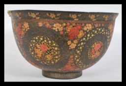 A 19th century Indian Kashmir papier mache bowl raised on a circular foot having decoration of