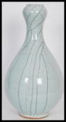 A 20th Century Chinese garlic mouth baluster crackle glaze vase. The baluster body having tapered