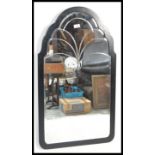 A vintage early 20th Century Art Deco cast metal wall mirror of arched form. Measures 93cm high x