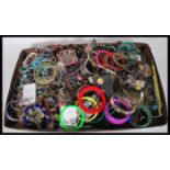 A collection of vintage costume jewellery to include bracelets, bangles, beads, etc.