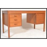 A retro 20th Century teak twin pedestal desk, flared top with a pedestal of three drawers to the